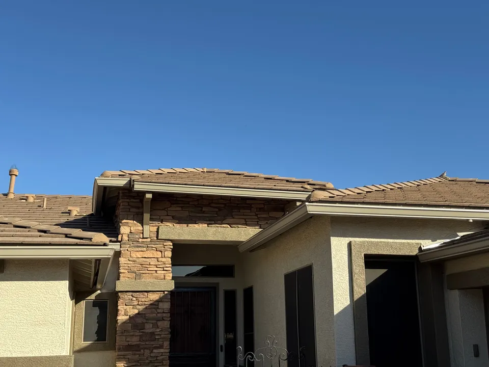 Dark bronze seamless gutters on a modern stucco home