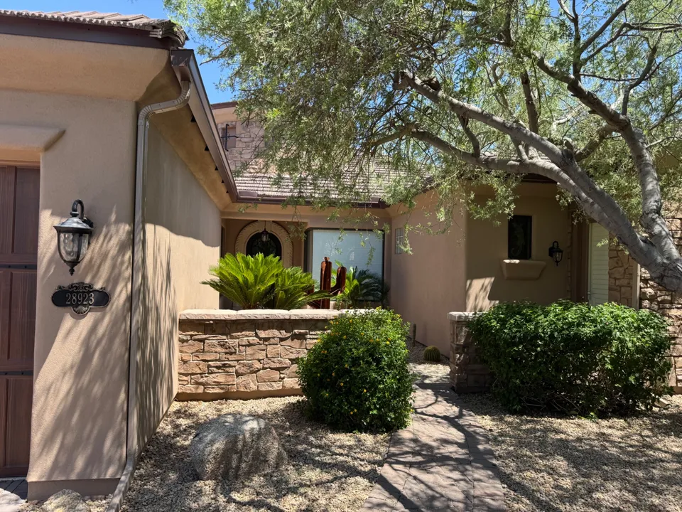 Seamless gutters over a covered entry with a stone planter